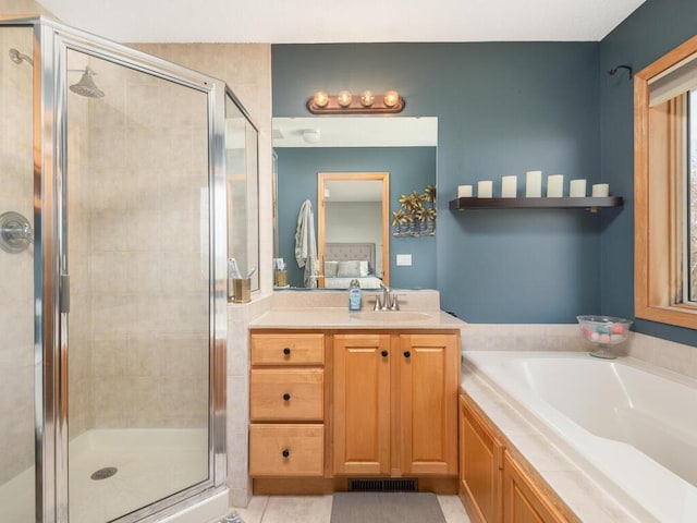 16850 Willowwood Cir SE, Prior Lake, MN 55372 - bathroom featuring vanity, a shower stall, a bath, and tile patterned floors