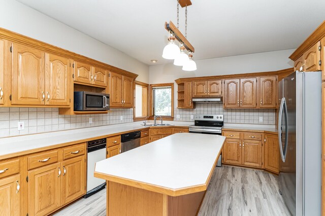 2310 Wilshire Ln NE, Rochester, MN 55906 - kitchen featuring appliances with stainless steel finishes, under cabinet range hood, a sink, light wood finished floors, and light countertops