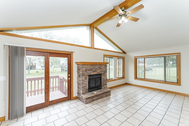 2310 Wilshire Ln NE, Rochester, MN 55906 - unfurnished living room featuring baseboards, light tile patterned floors, a ceiling fan, and a stone fireplace