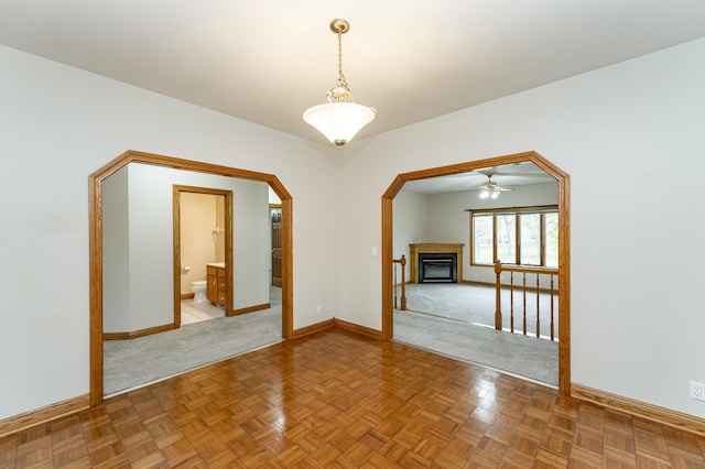 2310 Wilshire Ln NE, Rochester, MN 55906 - unfurnished room with baseboards, a fireplace, light carpet, and arched walkways