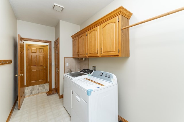 2310 Wilshire Ln NE, Rochester, MN 55906 - laundry area featuring cabinet space, washing machine and clothes dryer, light floors, and baseboards