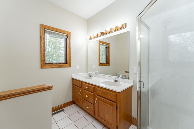 2310 Wilshire Ln NE, Rochester, MN 55906 - bathroom with double vanity, a shower stall, tile patterned floors, and baseboards