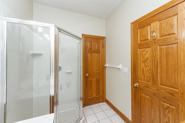 2310 Wilshire Ln NE, Rochester, MN 55906 - bathroom featuring a shower stall, tile patterned flooring, and baseboards