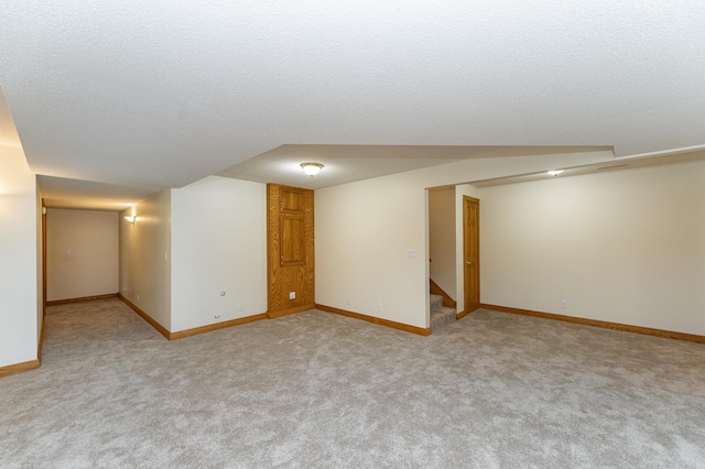 2310 Wilshire Ln NE, Rochester, MN 55906 - finished below grade area featuring light carpet, baseboards, and stairway