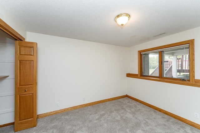 2310 Wilshire Ln NE, Rochester, MN 55906 - carpeted spare room with baseboards and a textured ceiling