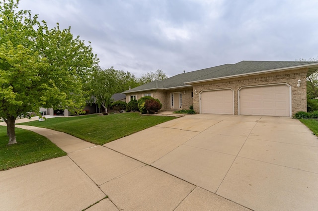 2310 Wilshire Ln NE, Rochester, MN 55906 - view of front of house with a garage, concrete driveway, a front lawn, brick siding, and roof with shingles