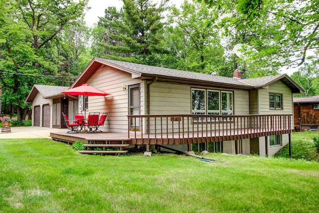14070 County 18, Park Rapids, MN 56470 - view of front facade with a wooden deck, a chimney, roof with shingles, a garage, and a front lawn