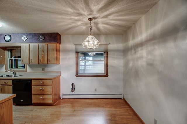14070 County 18, Park Rapids, MN 56470 - kitchen with black dishwasher, a baseboard heating unit, a sink, a chandelier, and light countertops