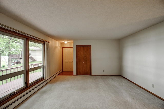 14070 County 18, Park Rapids, MN 56470 - unfurnished room featuring baseboard heating, light carpet, baseboards, and a textured ceiling