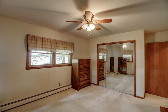 14070 County 18, Park Rapids, MN 56470 - unfurnished bedroom featuring baseboard heating, light carpet, a closet, and ceiling fan
