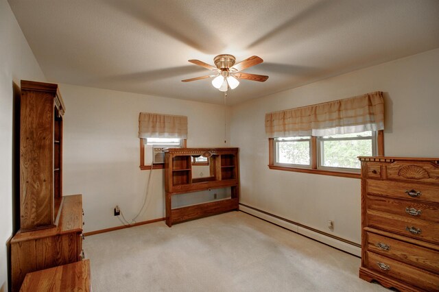 14070 County 18, Park Rapids, MN 56470 - unfurnished bedroom featuring a baseboard heating unit, light colored carpet, baseboards, and a ceiling fan
