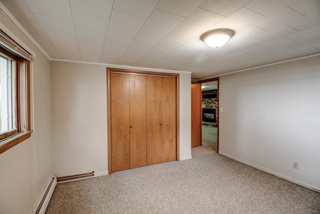 14070 County 18, Park Rapids, MN 56470 - unfurnished bedroom featuring carpet flooring, a closet, ornamental molding, a baseboard radiator, and baseboards