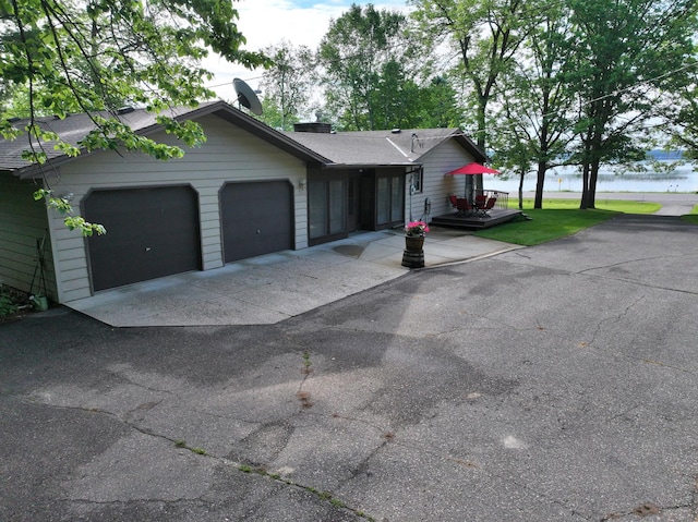 14070 County 18, Park Rapids, MN 56470 - ranch-style house with a garage, driveway, a water view, and a chimney