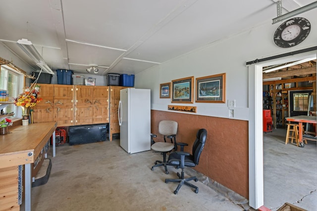 35301 Lily St NW, Springvale Twp, MN 55008 - garage featuring freestanding refrigerator and a workshop area