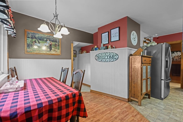 35301 Lily St NW, Springvale Twp, MN 55008 - dining room featuring a chandelier, wainscoting, and wood finished floors