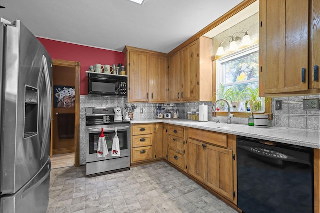 35301 Lily St NW, Springvale Twp, MN 55008 - kitchen with black appliances, tasteful backsplash, a sink, and brown cabinetry