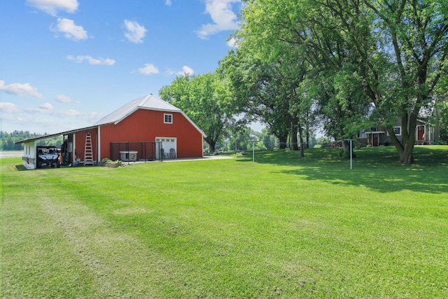 35301 Lily St NW, Springvale Twp, MN 55008 - view of green lawn featuring a detached garage, an outbuilding, central AC, and driveway