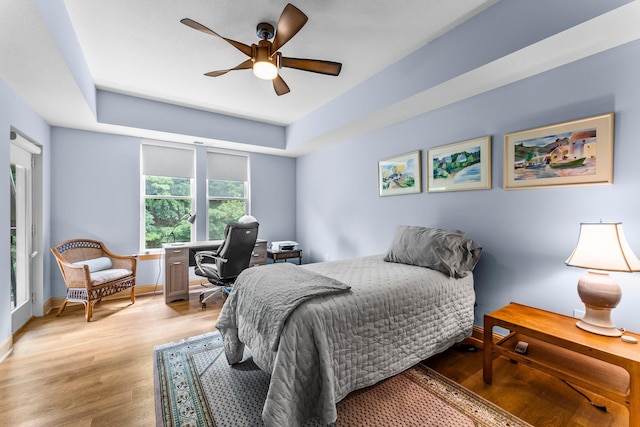620 Main St N Unit 412, Stillwater, MN 55082 - bedroom featuring wood finished floors, a raised ceiling, a ceiling fan, and an office area