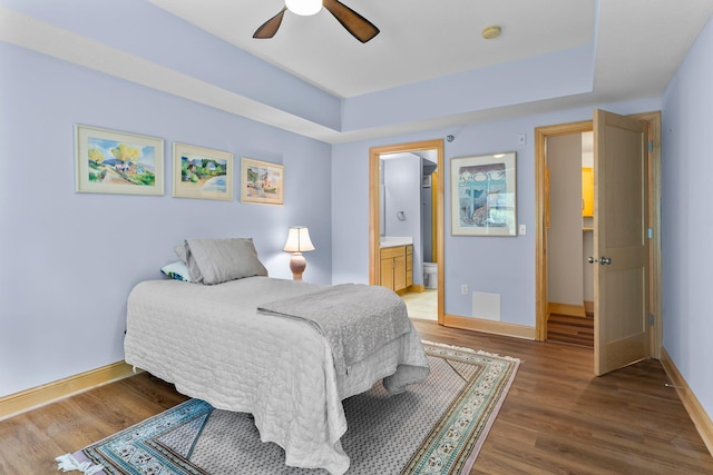 620 Main St N Unit 412, Stillwater, MN 55082 - bedroom featuring wood finished floors, a tray ceiling, and ensuite bathroom