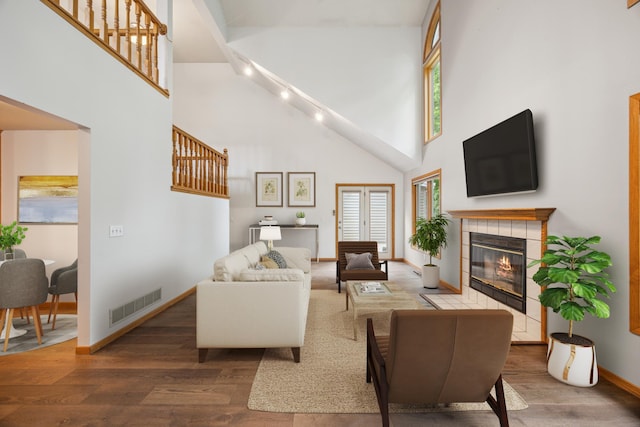 7813 111th St, Bloomington, MN 55438 - living area featuring high vaulted ceiling, wood finished floors, plenty of natural light, and a tile fireplace