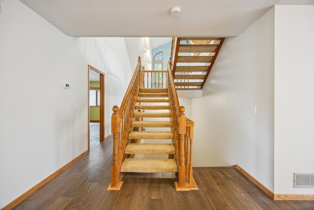 7813 111th St, Bloomington, MN 55438 - stairway with wood finished floors and a textured ceiling