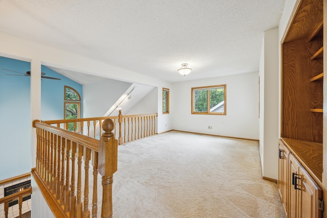 7813 111th St, Bloomington, MN 55438 - hall with light carpet, an upstairs landing, a textured ceiling, and vaulted ceiling