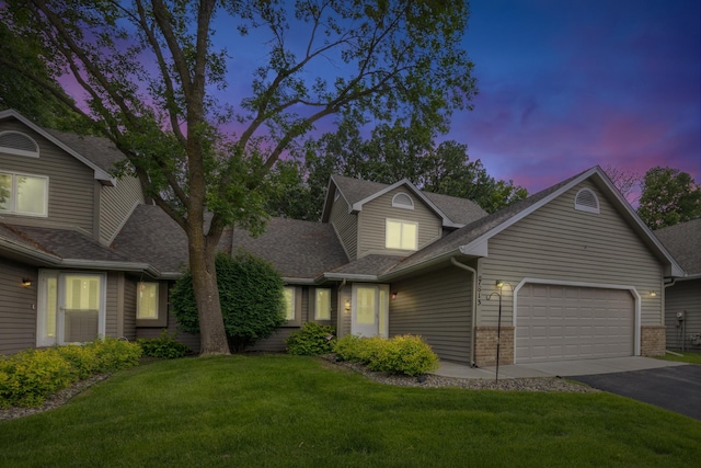 7813 111th St, Bloomington, MN 55438 - traditional home featuring roof with shingles, a garage, driveway, a front lawn, and brick siding