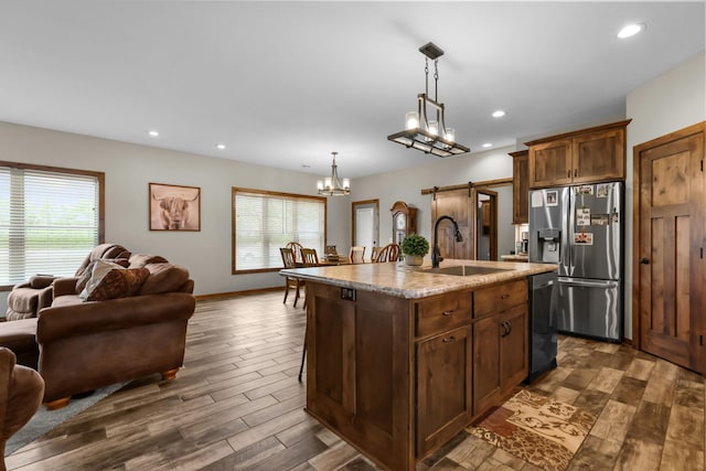 5855 281st Ave NW, Spencer Brook Twp, MN 55040 - kitchen featuring stainless steel fridge with ice dispenser, a sink, open floor plan, dishwasher, and dark wood-style floors