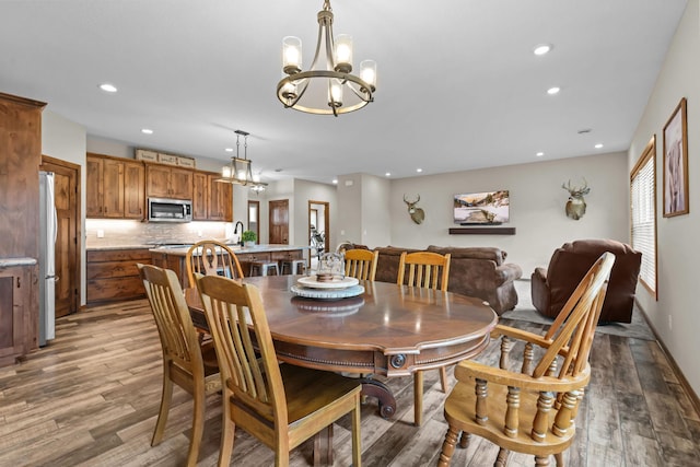 5855 281st Ave NW, Spencer Brook Twp, MN 55040 - dining room featuring a chandelier, recessed lighting, and wood finished floors