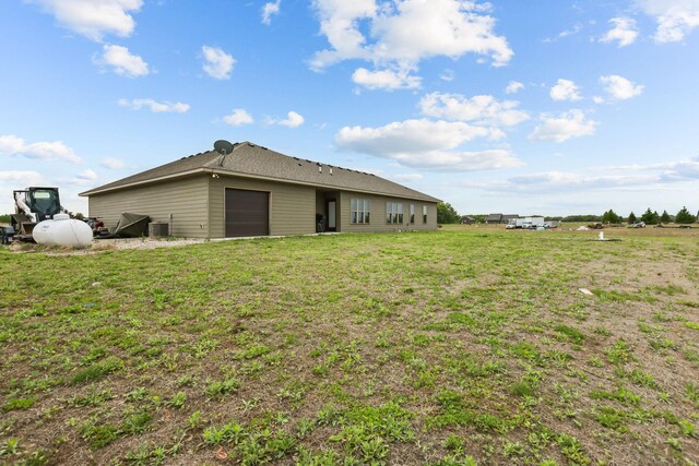 5855 281st Ave NW, Spencer Brook Twp, MN 55040 - view of green lawn featuring cooling unit and a garage