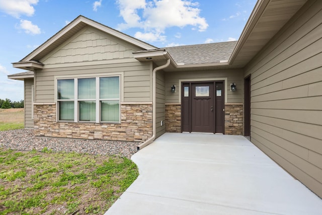 5855 281st Ave NW, Spencer Brook Twp, MN 55040 - property entrance with stone siding and roof with shingles