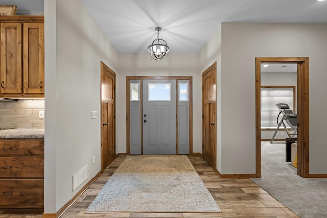 5855 281st Ave NW, Spencer Brook Twp, MN 55040 - entryway featuring light wood-style floors and a chandelier