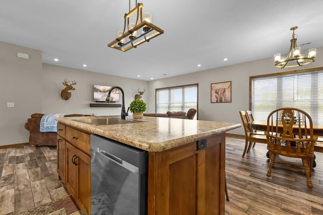 5855 281st Ave NW, Spencer Brook Twp, MN 55040 - kitchen with dishwasher, a chandelier, brown cabinetry, dark wood-type flooring, and hanging light fixtures