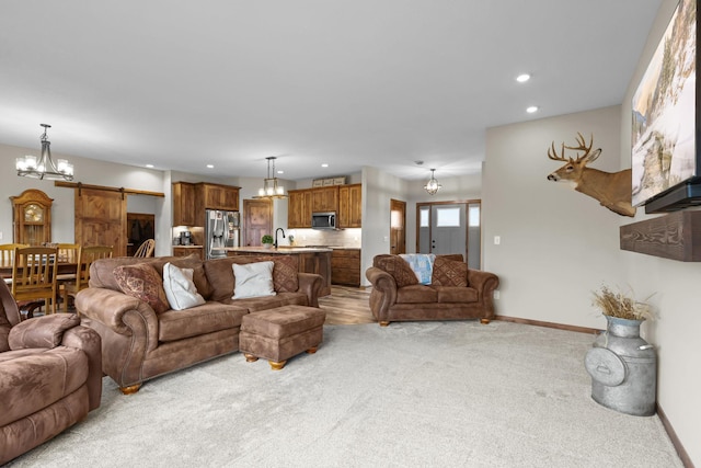 5855 281st Ave NW, Spencer Brook Twp, MN 55040 - living room with a barn door, a chandelier, carpet, and recessed lighting