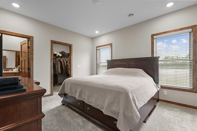 5855 281st Ave NW, Spencer Brook Twp, MN 55040 - bedroom with light carpet, multiple windows, a spacious closet, and recessed lighting
