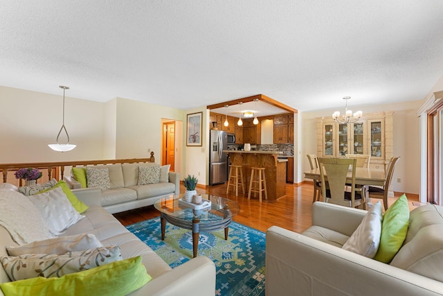 4427 Chatsworth St N, Shoreview, MN 55126 - living room featuring a chandelier, dark wood-type flooring, and a textured ceiling