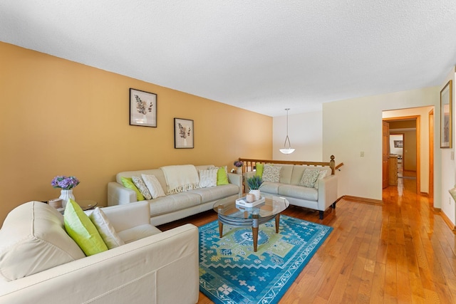 4427 Chatsworth St N, Shoreview, MN 55126 - living area with light wood finished floors, baseboards, and a textured ceiling