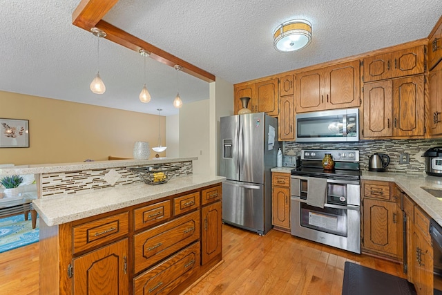 4427 Chatsworth St N, Shoreview, MN 55126 - kitchen with appliances with stainless steel finishes, a textured ceiling, tasteful backsplash, brown cabinets, and light wood-type flooring