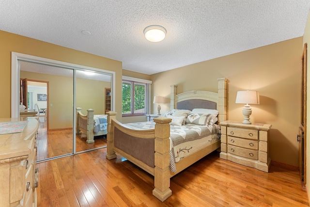 4427 Chatsworth St N, Shoreview, MN 55126 - bedroom with light wood finished floors, a closet, a textured ceiling, and baseboards