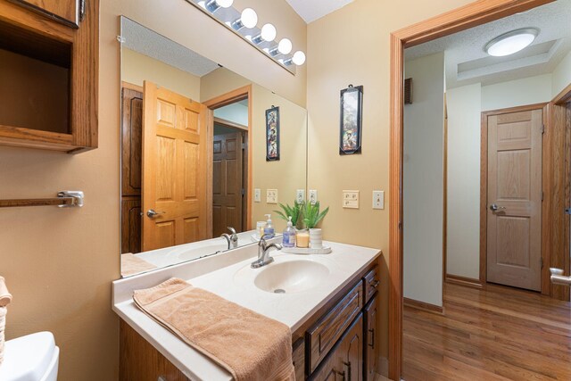 4427 Chatsworth St N, Shoreview, MN 55126 - half bath featuring vanity, toilet, wood finished floors, and baseboards