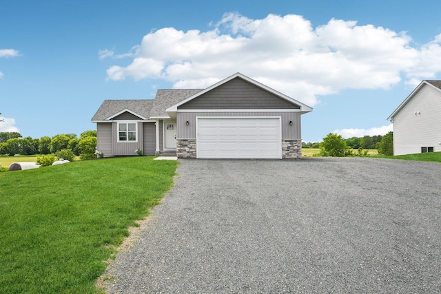 1019 188th St, Garfield Twp, WI 54009 - craftsman-style house with stone siding, an attached garage, a front lawn, driveway, and board and batten siding