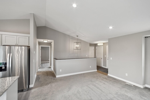 1019 188th St, Garfield Twp, WI 54009 - unfurnished living room featuring vaulted ceiling, carpet, a chandelier, and recessed lighting