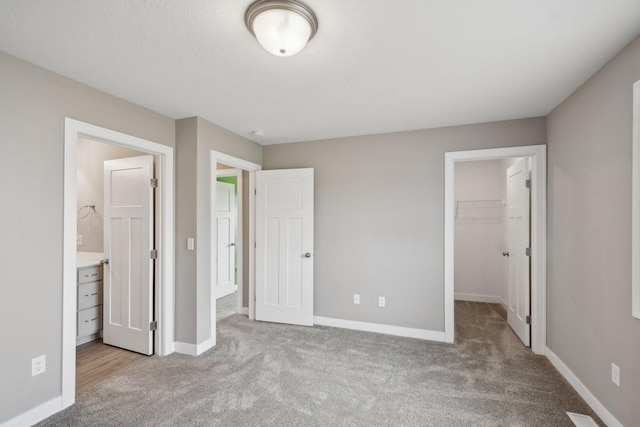 1019 188th St, Garfield Twp, WI 54009 - unfurnished bedroom featuring carpet floors, a walk in closet, a closet, and connected bathroom