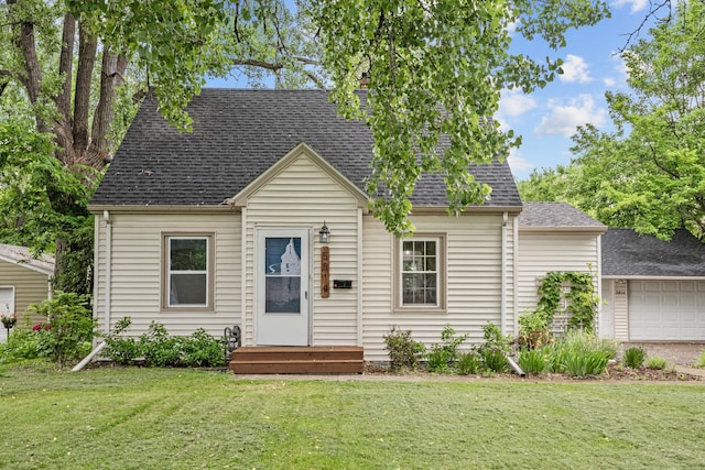 5814 Ewing Ave N, Brooklyn Center, MN 55429 - cape cod home with a front lawn, roof with shingles, and a garage