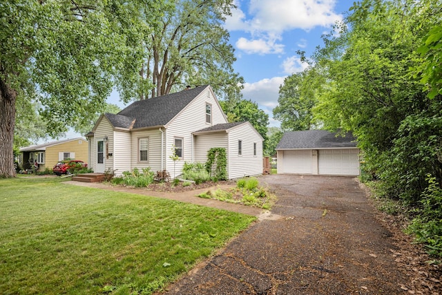 5814 Ewing Ave N, Brooklyn Center, MN 55429 - view of front of house with a detached garage, an outdoor structure, a front yard, and roof with shingles