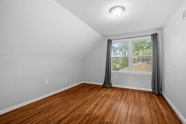5814 Ewing Ave N, Brooklyn Center, MN 55429 - bonus room featuring hardwood / wood-style flooring and vaulted ceiling