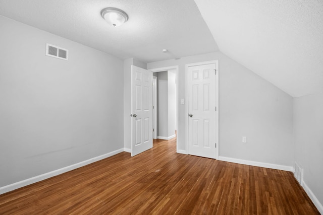 5814 Ewing Ave N, Brooklyn Center, MN 55429 - bonus room with wood finished floors, lofted ceiling, and a textured ceiling