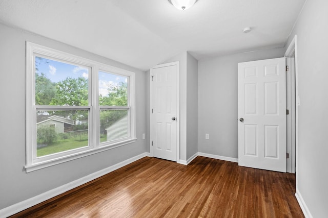 5814 Ewing Ave N, Brooklyn Center, MN 55429 - unfurnished bedroom with lofted ceiling and wood finished floors