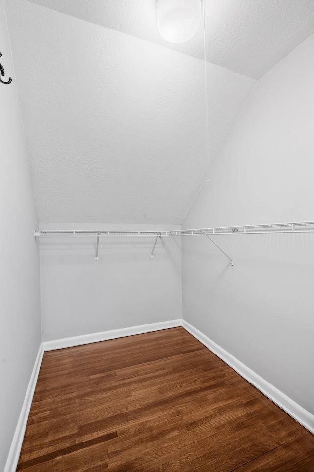 5814 Ewing Ave N, Brooklyn Center, MN 55429 - walk in closet featuring lofted ceiling and wood finished floors