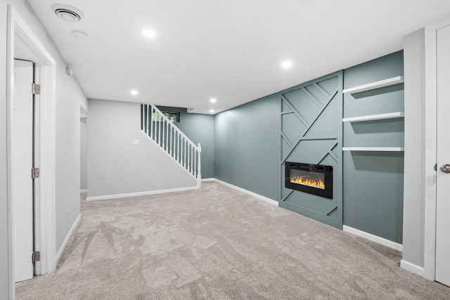 5814 Ewing Ave N, Brooklyn Center, MN 55429 - finished below grade area featuring carpet, a glass covered fireplace, stairway, and recessed lighting